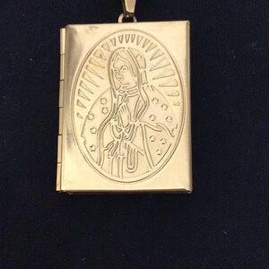 New gold colorized process stainless steel chain with holy mother Mary locket.